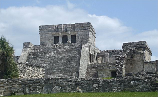 This is the Temple of Tulum. The steps leading to the top are very narrow and steep, forcing one to look down at their feet when climbing to the top, showing respect to the building and to Kukulkan (the plumed serpent).