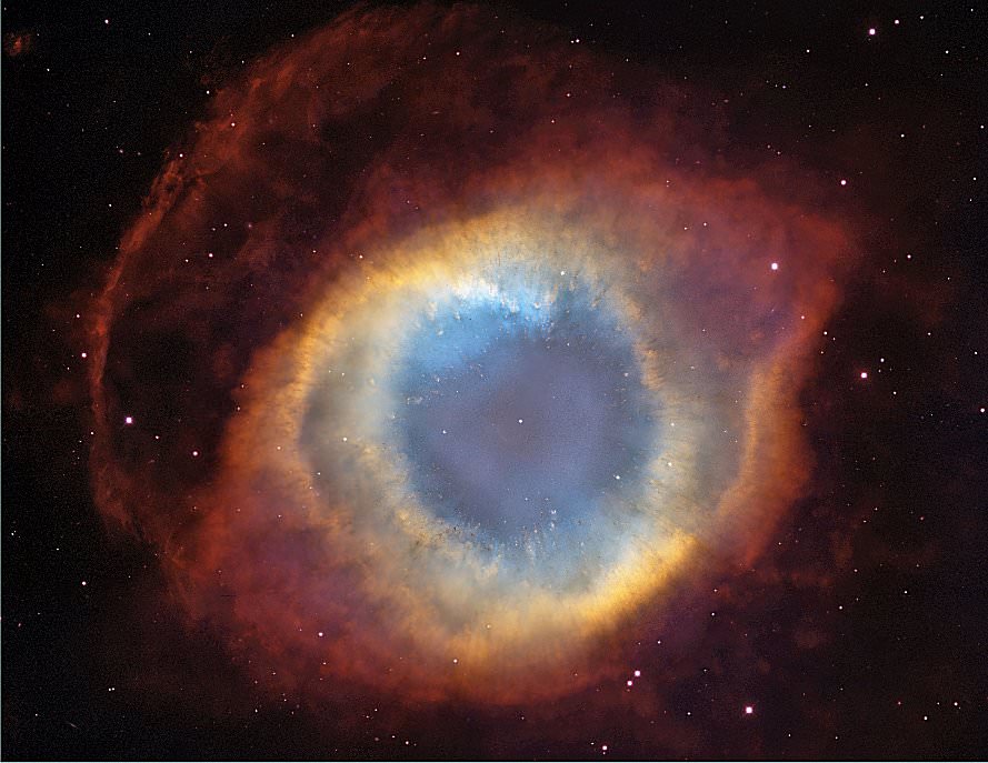 This image of the NGC 7293 Helix Nebula, or the “Eye of God,” was taken by the Hubble Space Telescope. The Helix Nebula is a typical example of a planetary nebula because it emerged as a result of the explosion of a sun-like star. Generally speaking, hydrogen gas is the most common component of the interstellar medium, also known as the vast space between stars and planetary systems in galaxies. Hydrogen gas in space exists primarily in its atomic and molecular form, and makes up huge clouds throughout the entire galaxy.