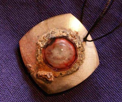This Ruby Eye Pendant from an ancient Mesopotamia was used as a warding amulet to protect against the evil eye curse (Danieliness, Creative Commons)