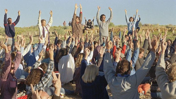 Celebrants raise their hands as the sun rises over the northwestern New Mexico landscape near Chaco Canyon, N.M., Aug. 16, 1987. About a thousand people participated in various activities, part of the “harmonic convergence” including chanting, prayer and meditation. (AP Photo/David Breslauer)