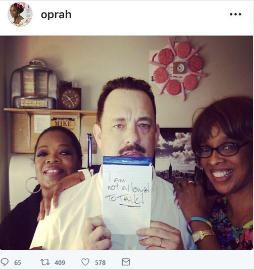 Oprah and Gayle King trying to protect Tom Hanks in this weird post they made. Nice hotdog clock too.