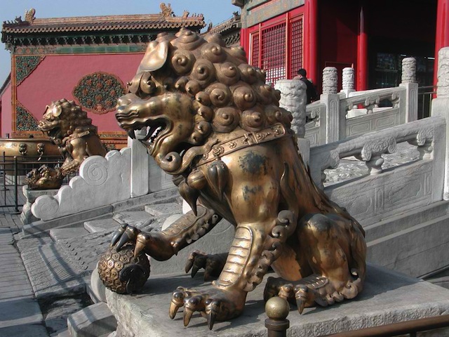 Qing “Guardian Lions” holding some objects with their right paws. One is holding a baby lion, the other a Flower of Life sphere.