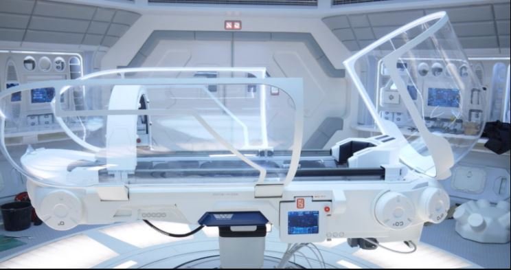 The Holographic Medbed is a medical bed that utilizes advanced artificial intelligence and physician oversight to ensure optimal healing. It features transparent, airtight operating shields, laser mirrors, comfortable limb supports, computer-controlled surgical arms, vital sign monitoring, display, and analysis capabilities. This med-bed is similar to an MRI machine, but does not use magnetic or radiation. It can perform detailed scans of the entire body to diagnose and treat illnesses quickly. Additionally, it can diagnose and treat neurological, skin, blood, DNA, organ, bone, muscle, gland, and hormonal deficiencies, as well as correct hereditary markers that lead to predisposition to certain diseases. It can also perform surgeries using laser technology